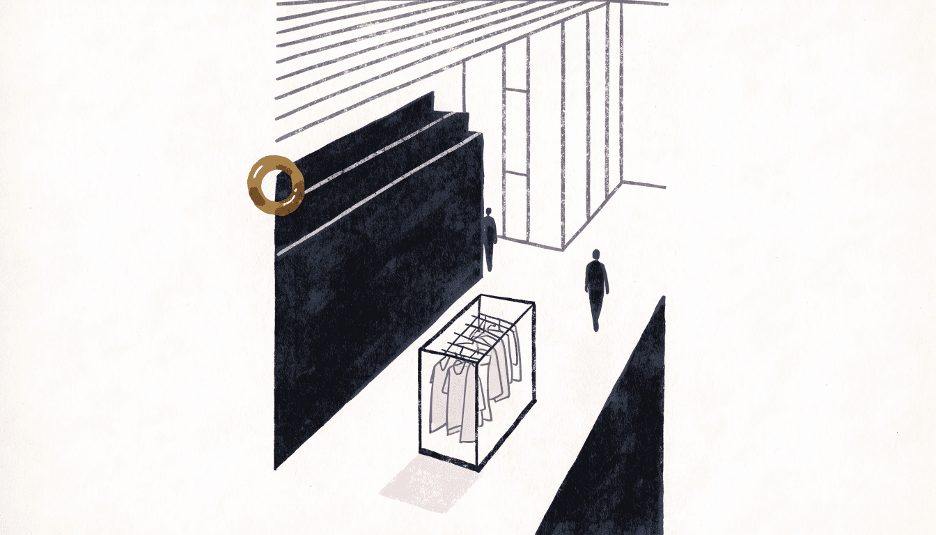 A quiet luxury floor with a rack of soft knitwear and a silhouette shopper, one brass accent.