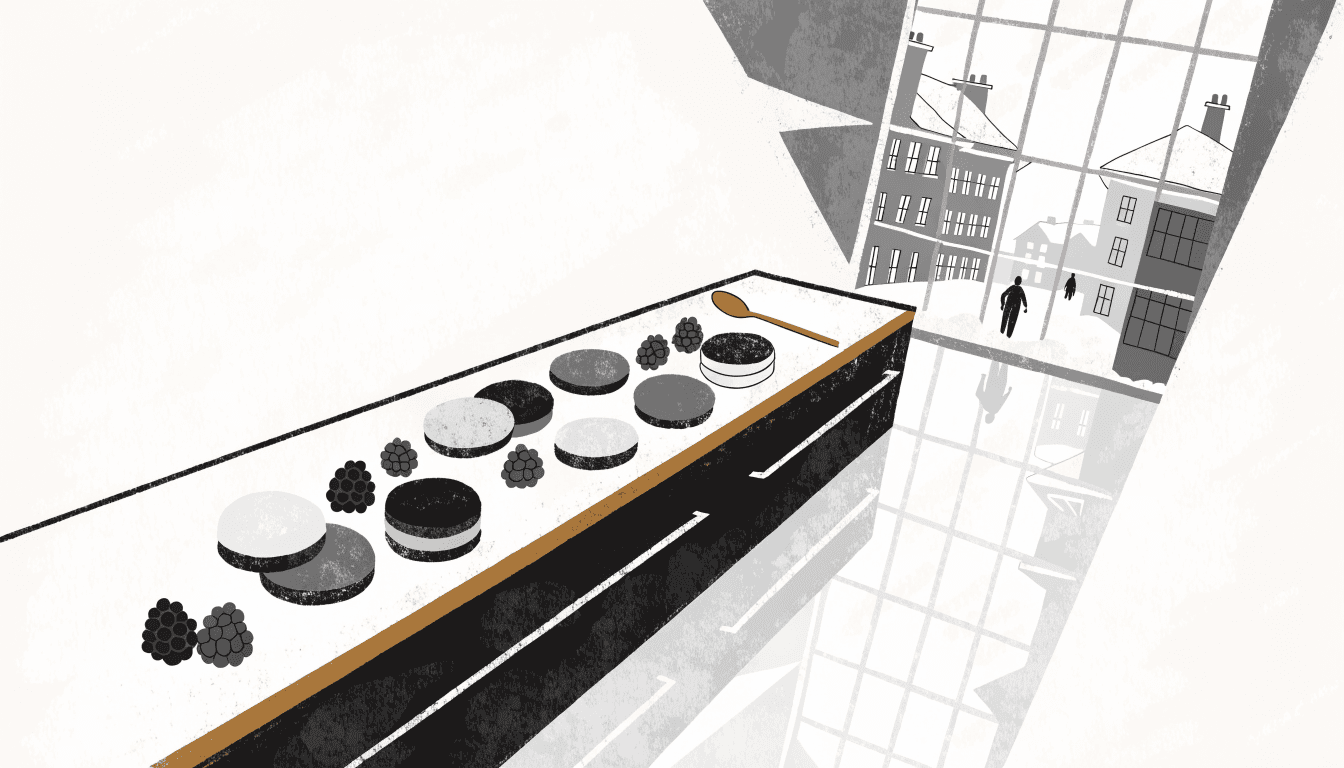 A food-hall counter lined with thin chocolates and raspberries, a snowy street beyond the window.