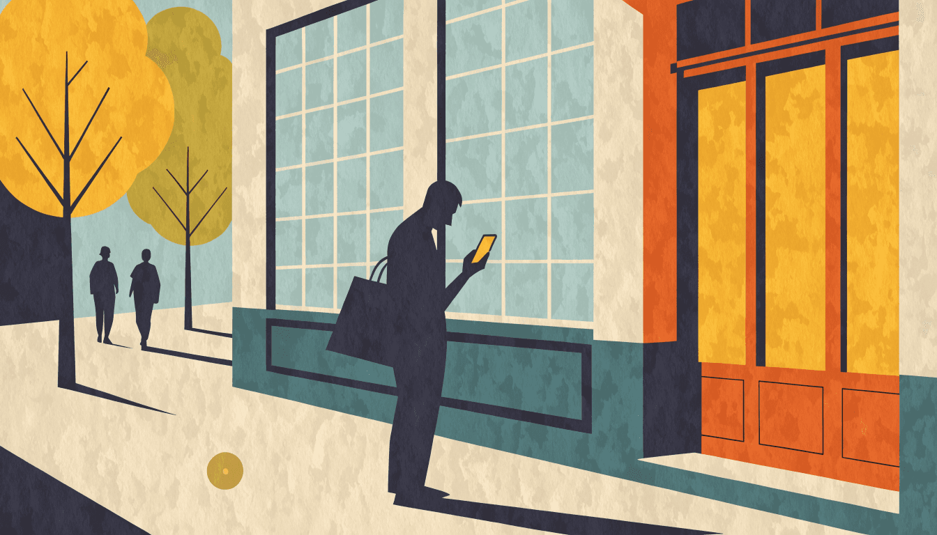 A shopper checking a smartphone outside a boutique storefront on a tree-lined street